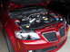 1992 Ford Taurus - Engine bay of a red car, a V8 engine and aftermarket intake system.