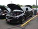1992 Ford Taurus - A black sedan, identified as a 2013 model by its body style and SHO badging, is displayed with its hood open at an event.
