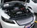 1992 Ford Taurus - The engine bay of a white Ford Taurus SHO, an EcoBoost engine and a toy police car.