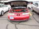 1992 Ford Taurus - A red 1992 Ford Taurus is parked with its hood open, revealing the engine compartment.