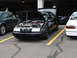 1992 Ford Taurus - A black 1992 Ford Taurus is parked with its hood open, revealing the engine, at a car show.