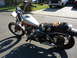 1985 Honda CMX250 Rebel - A weathered Honda motorcycle sits parked on a residential street, its seat showing significant wear and tear.