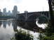 1992 Ford Taurus - A bridge spans a river, with a city skyline visible on the horizon and reflections in the water.