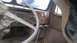 1959 Kenworth W900A - Interior view of a truck cab, showing the steering wheel, dashboard controls, and gear shifters.