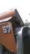 1959 Kenworth W900A - Close-up of a damaged truck fender with the number 57. The damage is significant, showing exposed internal structure.