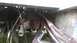 1959 Kenworth W900A - Close-up of a truck's drivetrain components, including the differential and drive shaft, with numerous hoses and wires visible.