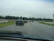 1992 Ford Taurus - A line of sedans drives on a wet track under an overcast sky.