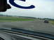 1992 Ford Taurus - Two cars are visible on a racetrack under an overcast sky.
