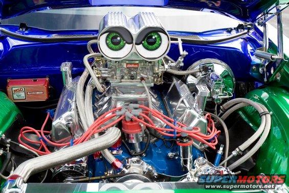 Customized V8 engine with dual carburetors, MSD ignition, and googly eyes on the air intake
