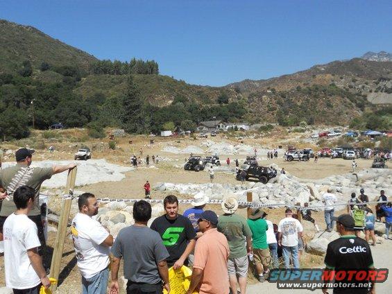 Off-road vehicles gathered at an outdoor event with spectators