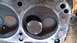 1973 Ford Torino - Close-up of a used engine cylinder head with visible wear and tear.