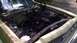 1973 Ford Torino - The engine bay of a 1973 Ford Torino, with the hood open, reveals its internal components during a motor rebuild.