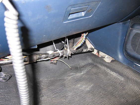Wires bundled with zip ties under dashboard, near floor mat