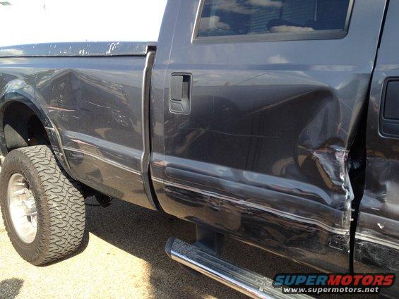 2006 Ford F-350 side with significant damage to rear quarter panel and door