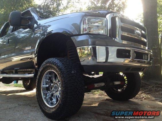 Front quarter view of a lifted Ford F-350 Super Duty truck with chrome wheels and tires