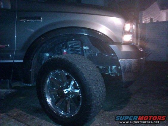 Front wheel and fender of a Ford Super Duty truck, likely 2005-2007 model year