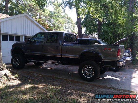Gray Ford F-350 Super Duty pickup truck parked in a driveway, side view