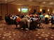 1992 Ford Taurus - A gathering of people seated at tables in a room, with a projector screen showing an image in the background.