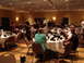 1992 Ford Taurus - A gathering of people are seated at round tables in a banquet hall, with some standing and mingling.