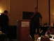 1992 Ford Taurus - A man addresses an audience from behind a wooden podium at an event.