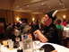1992 Ford Taurus - Attendees at a banquet event, some wearing novelty hats, are seated at tables with drinks.