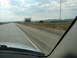 1992 Ford Taurus - Driving on a highway with a Wyoming welcome sign and rolling hills in the background.