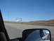 1992 Ford Taurus - Driving into Utah, reflected in the side mirror is a white truck and the "Welcome to Utah" sign.
