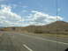 1992 Ford Taurus - Driving past the Arizona state line sign on a sunny day with a vast sky.