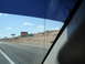 1992 Ford Taurus - View from inside a vehicle shows roadside signs indicating the Nevada state line under a bright, cloudy sky.