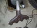 1978 Nissan 300ZX - Exhaust manifold and pipe assembly resting on a concrete floor.