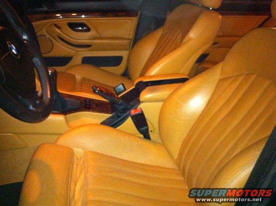 Tan leather interior of a 2000 BMW M5 with wood trim and a BMW steering wheel