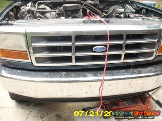 I had that rope tied to the radiator support where the hood latch was & then to the hood, where the safety catch was at on the hood along with a stick hood prop, so when you disassemble the hood from the swing hinges, the hood would not swing back into the windshield. It makes it easier to pull the hood off by your self.