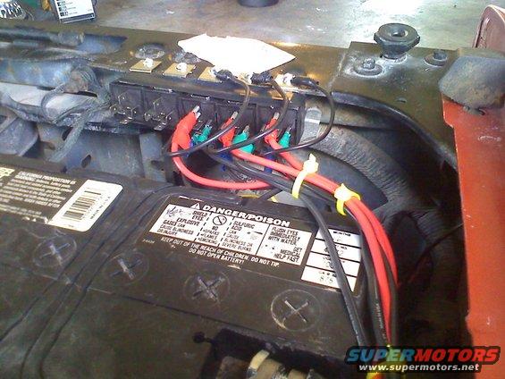 Engine bay with battery and fuse box wiring