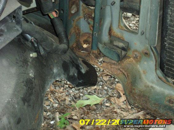 As you see here, this is why the past few months it took a crowbar to pop my hood. I would have to lift up on the left front corner of the hood because the bodymount under the left radiator core support was rotted out so badly. the weight of the radiator put the whole front clip off center, by a half inch or more.