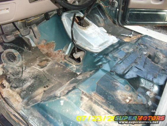 picture-036.jpg removing those old screws with 17 years of gunk in the corners, is no fun. 

If you want to cheat like i did, a nice sharp hacksaw blade can bend below the plastic corner edge of the T-case shift boot & can be hacked away without damaging anything but the screws you want out. 