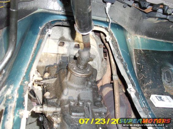 Removing the shift is pretty easy, just remove the nut with a 18 mm socket from the right side of the vehicle (Passenger side) and re-tighten the nut on the left side of the bolt (Driver's side). When it is completely tight, you might have to gently tap from the right side and it should just pop out.