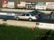 2003 Ford Crown Victoria - A silver Ford Crown Victoria competes in a drag race, with another car alongside it on the track.