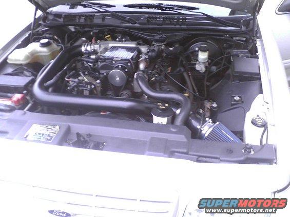 2003 Ford Crown Victoria engine bay showing supercharger and aftermarket air intake