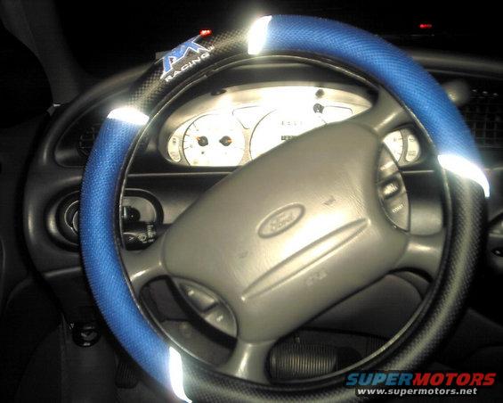 1997 Ford Taurus interior with blue steering wheel cover and Ford logo on steering wheel