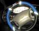 1997 Ford Taurus - The interior of a 1997 Ford Taurus is visible, a blue steering wheel cover and the Ford emblem on the steering wheel.