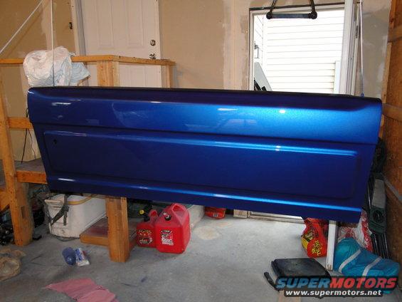 Blue tailgate on sawhorses in garage