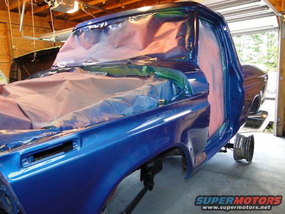 1978 Ford Bronco cab and front fender covered in masking paper during paint job