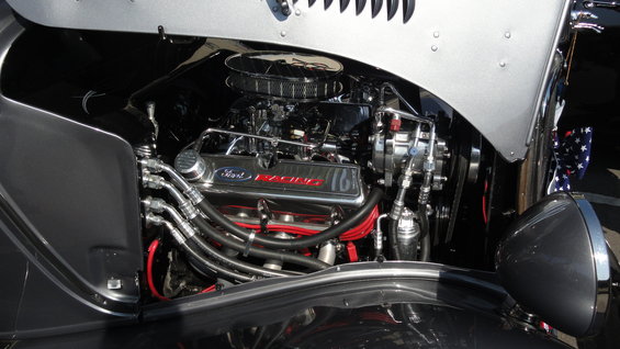 Close-up of a Ford V8 engine with chrome valve covers that say "Ford Racing"