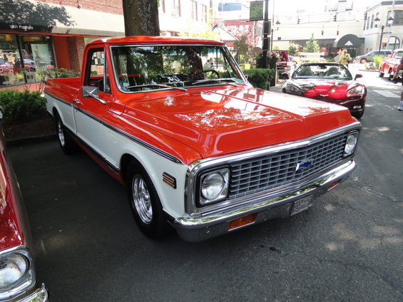 red and white pickup truck with chrome grille and blue bowtie emblem