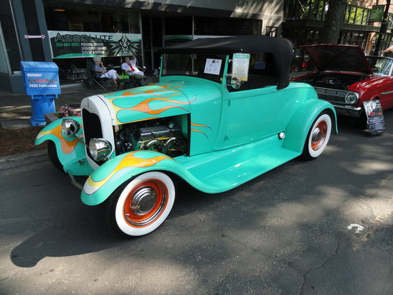Teal convertible hot rod with orange flames and white wall tires