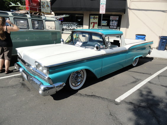 Two-tone turquoise and white pickup truck, front quarter view, with whitewall tires and chrome accents