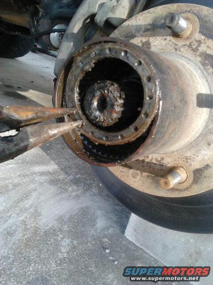 5.jpg with the first spindle nut out, use a pick or needlenose to take out the lock washer. once out, use the spindle nut socket to take out the last spindle nut