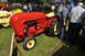 1959 Kenworth W900A - A red 1958 Porsche Diesel Junior tractor is displayed outdoors with people nearby.