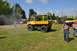 1959 Kenworth W900A - A yellow utility truck is parked on a grassy field during an outdoor event, with people walking nearby.