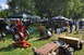 1959 Kenworth W900A - A gathering of antique engines and farm equipment displayed on a grassy field under trees.
